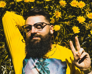 man laying in a field of flowers working on changing his mindset