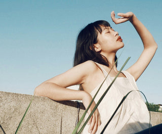 woman with her face in the sun practicing turning habits into daily rituals