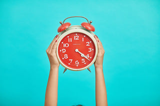 woman holding clock representing how long it takes for edibles to hit