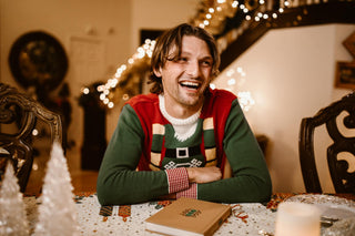 man at a cannabis christmas party wearing an elf sweater