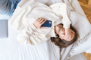 overwhelmed man lying on bed wondering how to rest